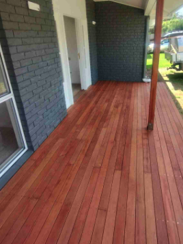 Stained porch decking against a Nashville bungalow brick wall